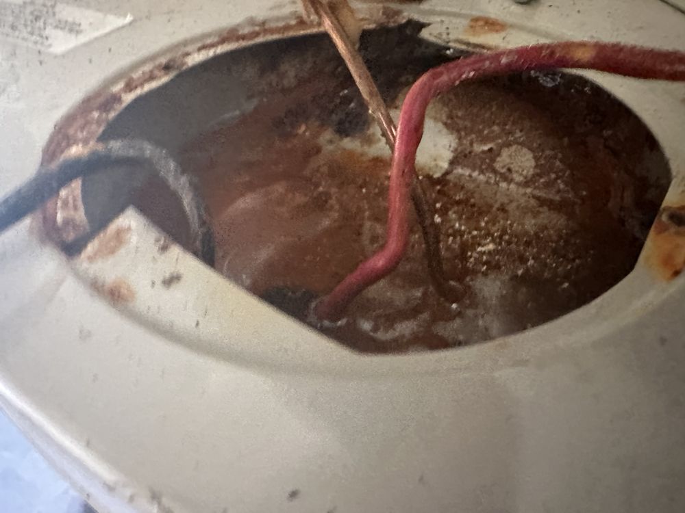 Corroded interior of water heater unit during tankless water heater repair in Wilmington, NC