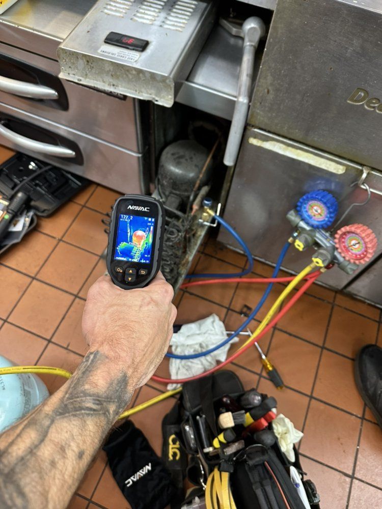 HVAC technician using thermal camera for commercial HVAC repair service in Wilmington, NC