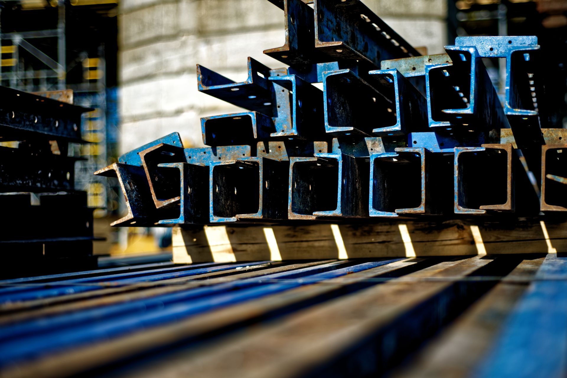 Stacks of steel rectangular tubes and rebar stored at an outdoor construction material yard Stacks of steel rectangular tubes and rebar stored at an outdoor construction material yard