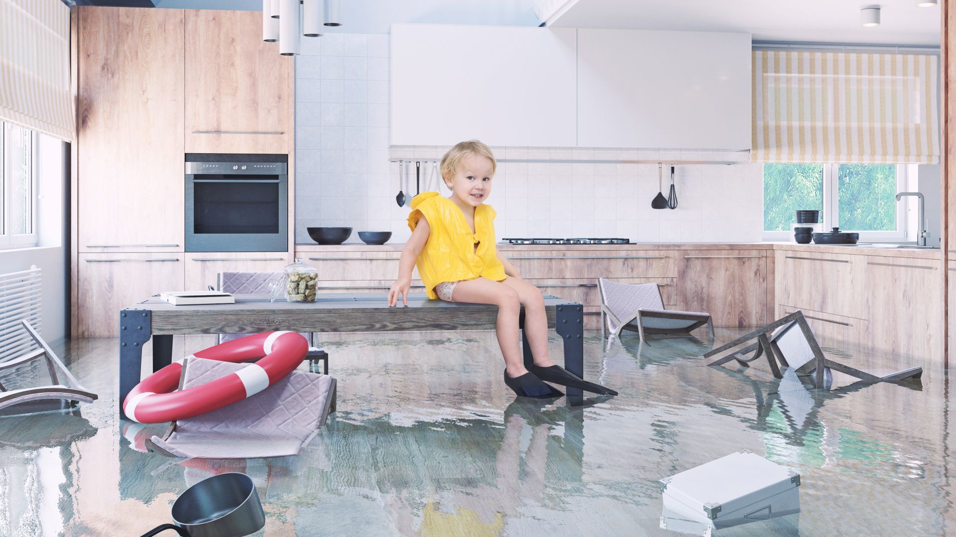 A little girl is sitting on a bench in a flooded kitchen.