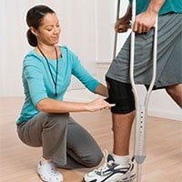 Physical Therapy — Therapist Treating The Man's Leg in Miami, FL