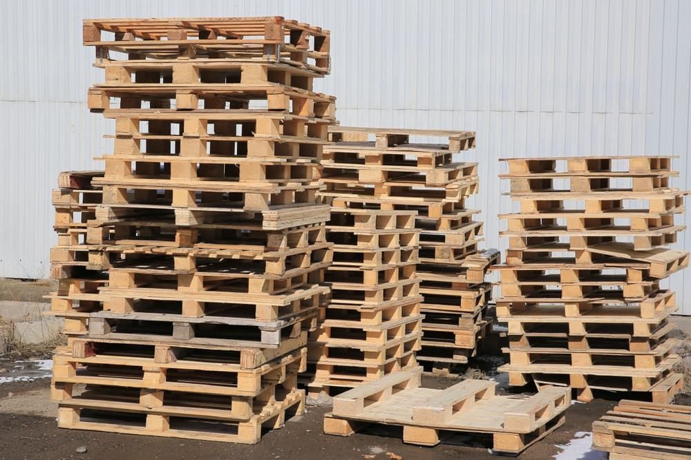 A Pile of Wooden Pallets Are Stacked on Top of Each Other — Adam's Sawmill in Port Macquarie, NSW