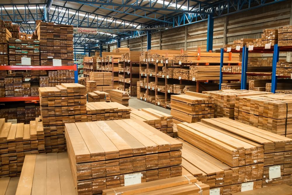 A Warehouse Filled with Lots of Wooden Boards Stacked on Top of Each Other — Adam's Sawmill in Bonville, NSW