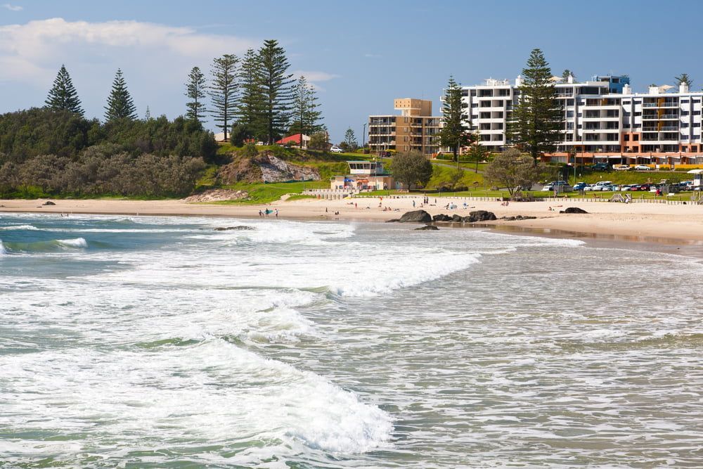 A Beach with A Lot of Buildings in The Background — Adam's Sawmill in Port Macquarie, NSW