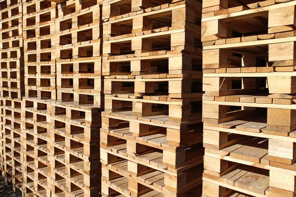 A Bunch of Wooden Pallets Are Stacked on Top of Each Other — Adam's Sawmill in Coffs Harbour, NSW