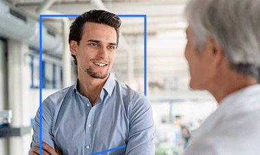 A man with his arms crossed is talking to another man