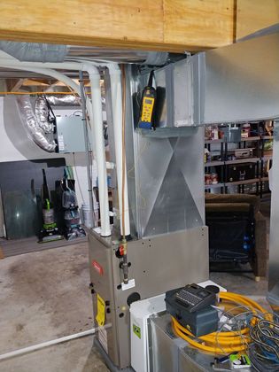 A heating and cooling system is installed in a basement.