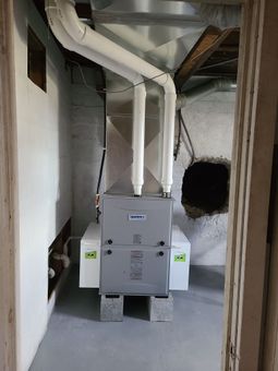 A heating and cooling system is installed in a basement.