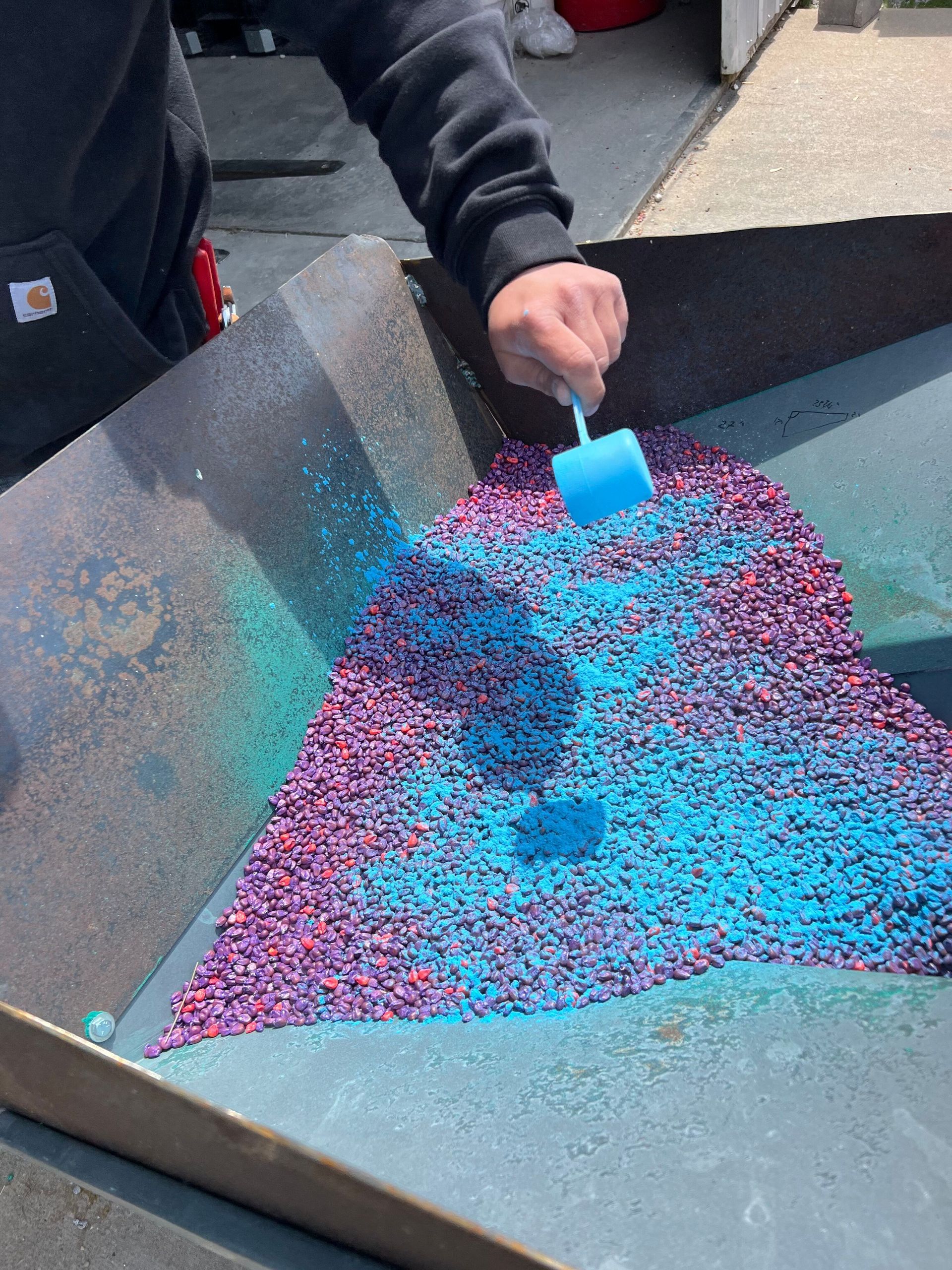 A person is holding a pile of fertilizer in their hands.