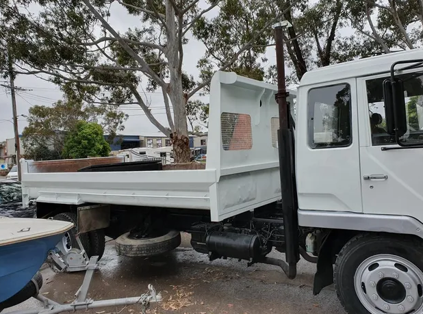 White truck being repaired  — Castledine's Truck Painting & Repairs in Fountaindale, NSW