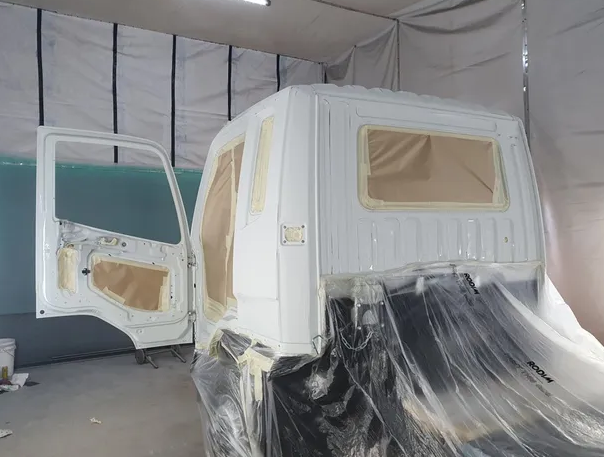 White truck being spray painted — Castledine's Truck Painting & Repairs in Fountaindale, NSW