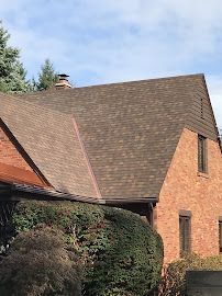 Red House with Bricked Roof 2 — Erie, PA — Advanced Roofing and Construction