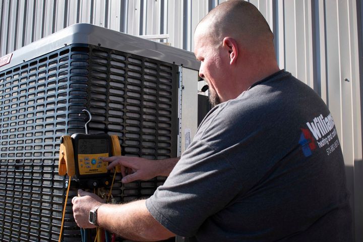 Man Fixing an Air Conditioner | Sullivan, MO | Williams heating and cooling