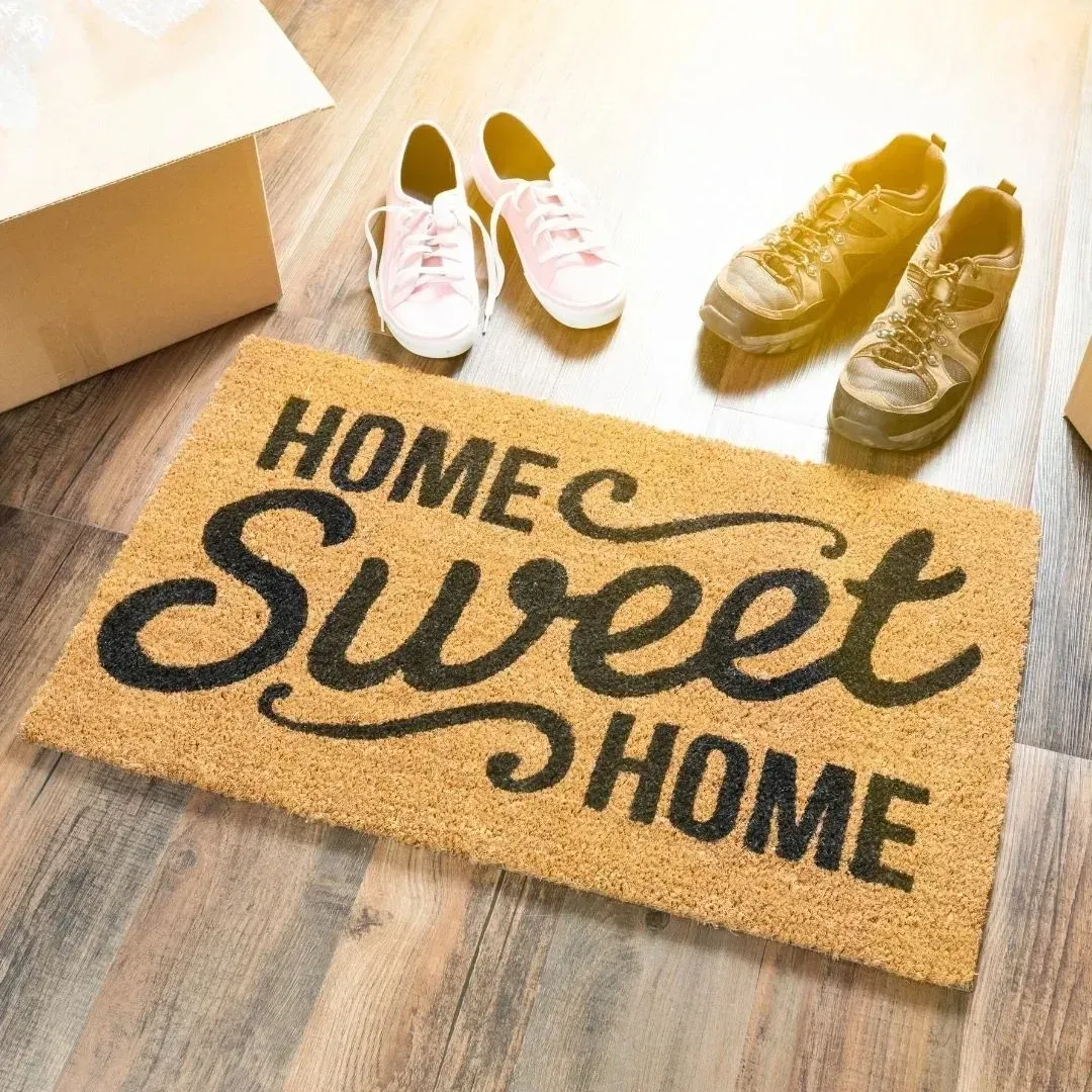 A door mat that says home sweet home on it