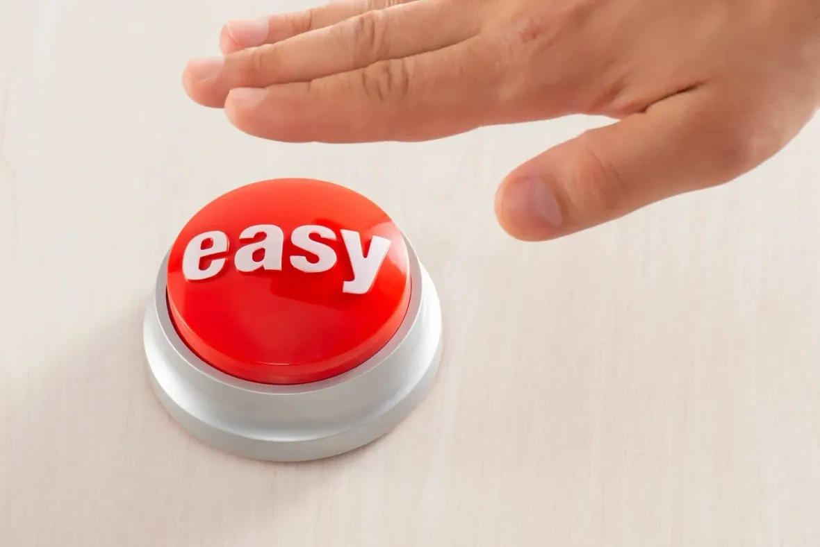 A person is pressing an easy button with their finger.