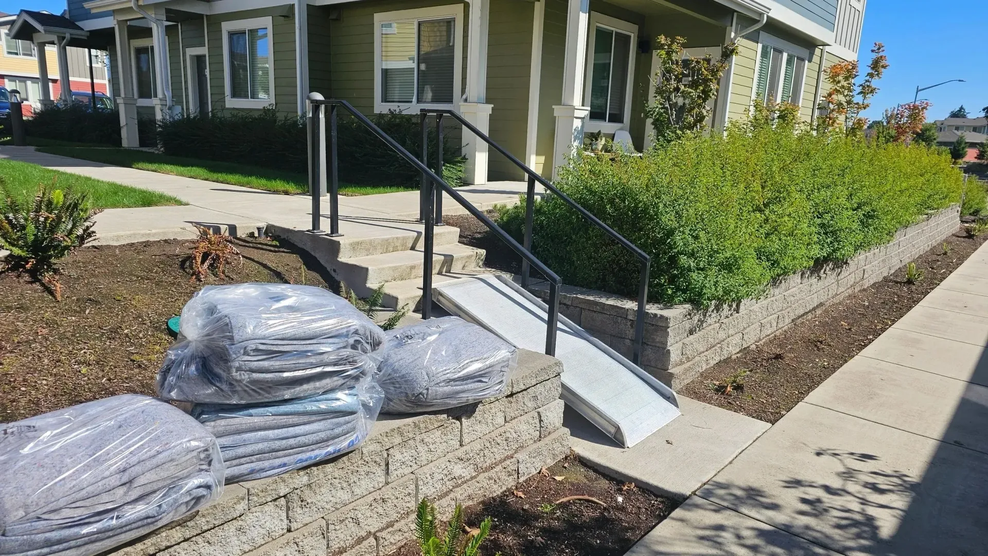 A house with a ramp and stairs in front of it.