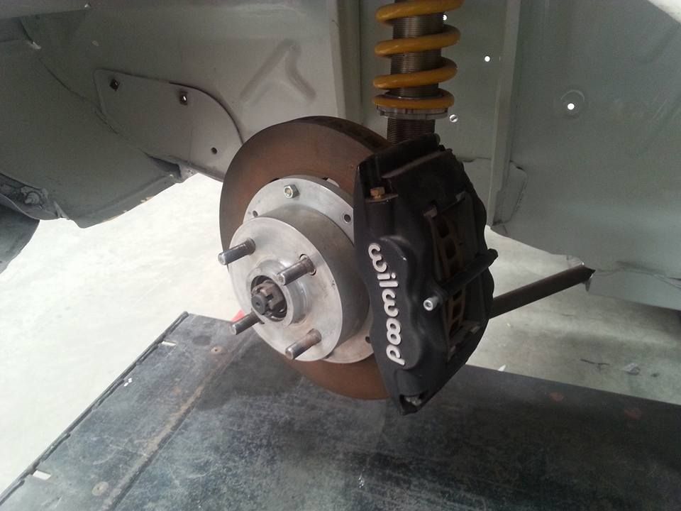 A close up of a wilwood brake on a car.