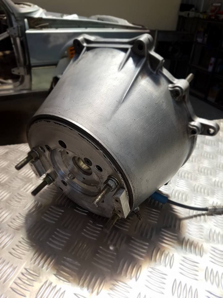 A large metal object is sitting on top of a metal table.