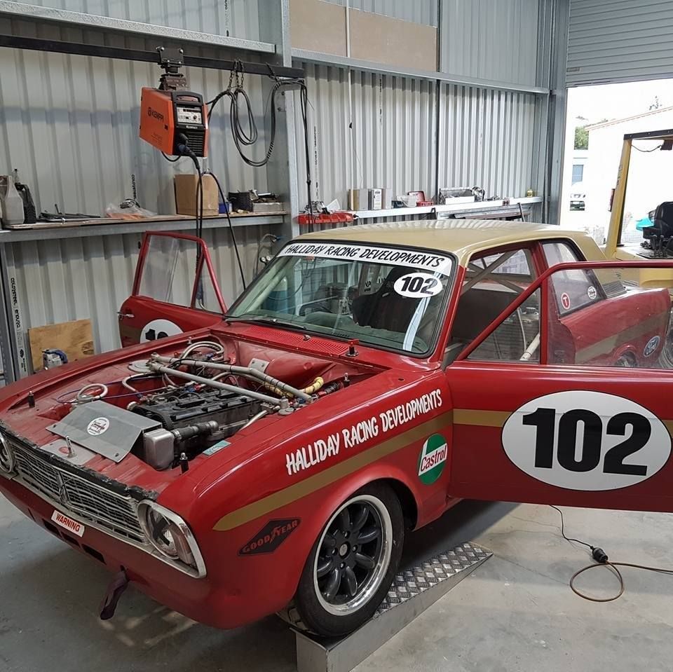 A red race car with the number 102 on the side.