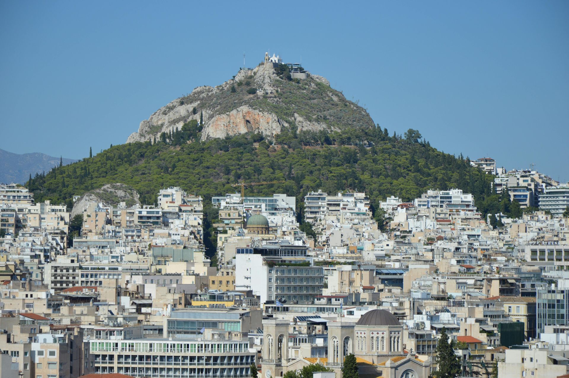 View of the Parthenon atop the Acropolis hill in Athens on a sunny day