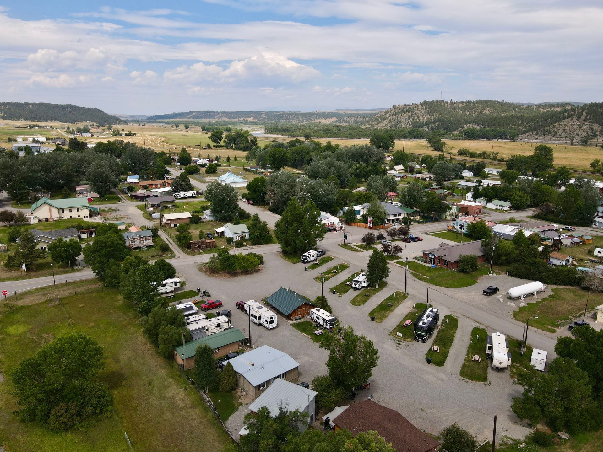 An aerial view of a grassy field surrounded by trees.