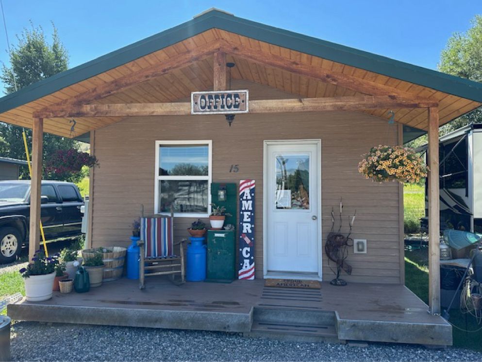 Small, brown office building with porch, 