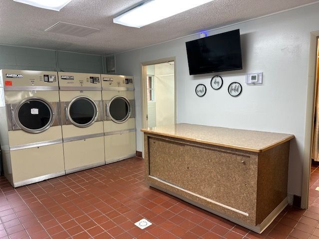 A laundromat with a lot of washers and dryers