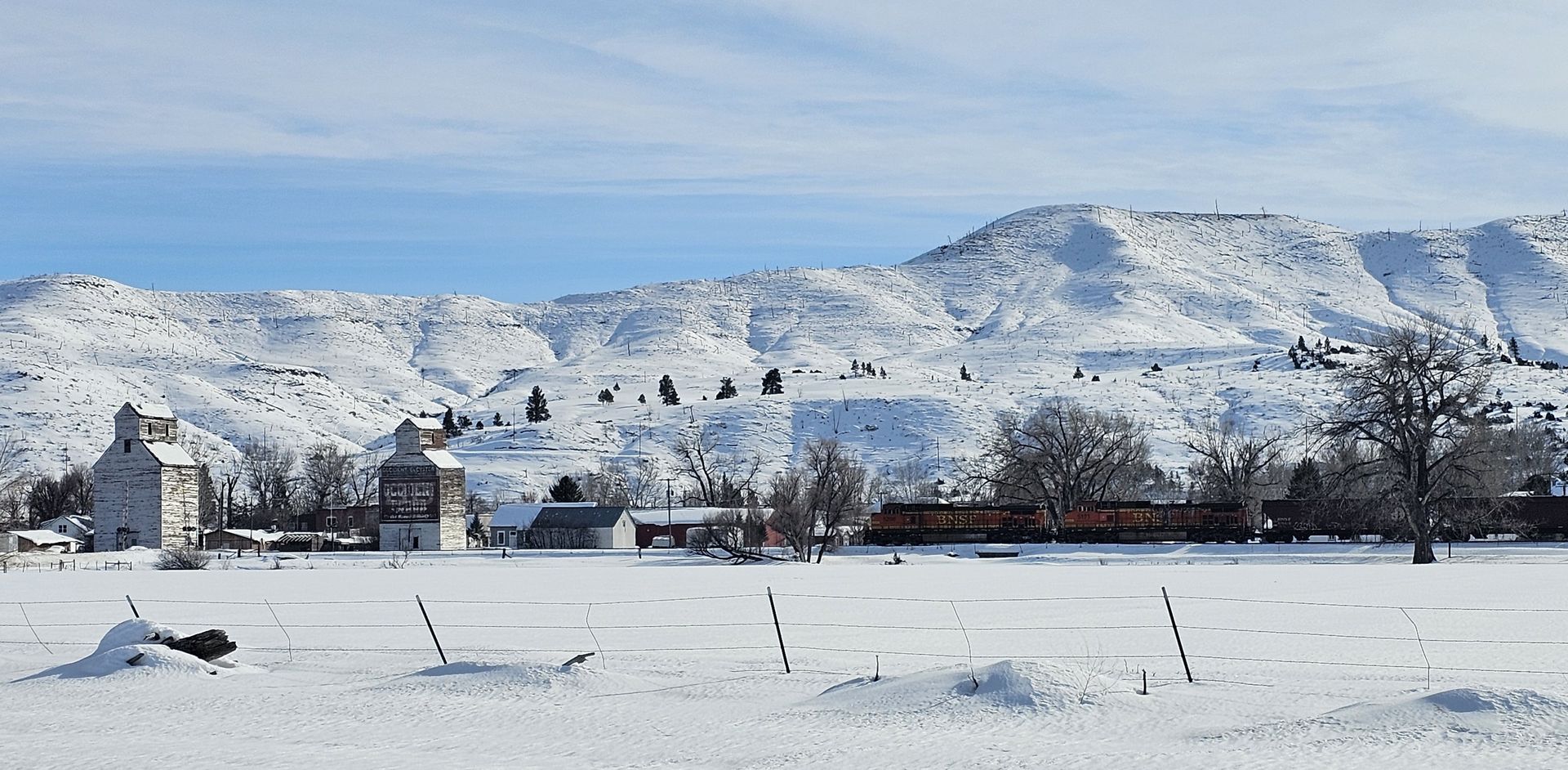 A snowy field with mountains in the background
