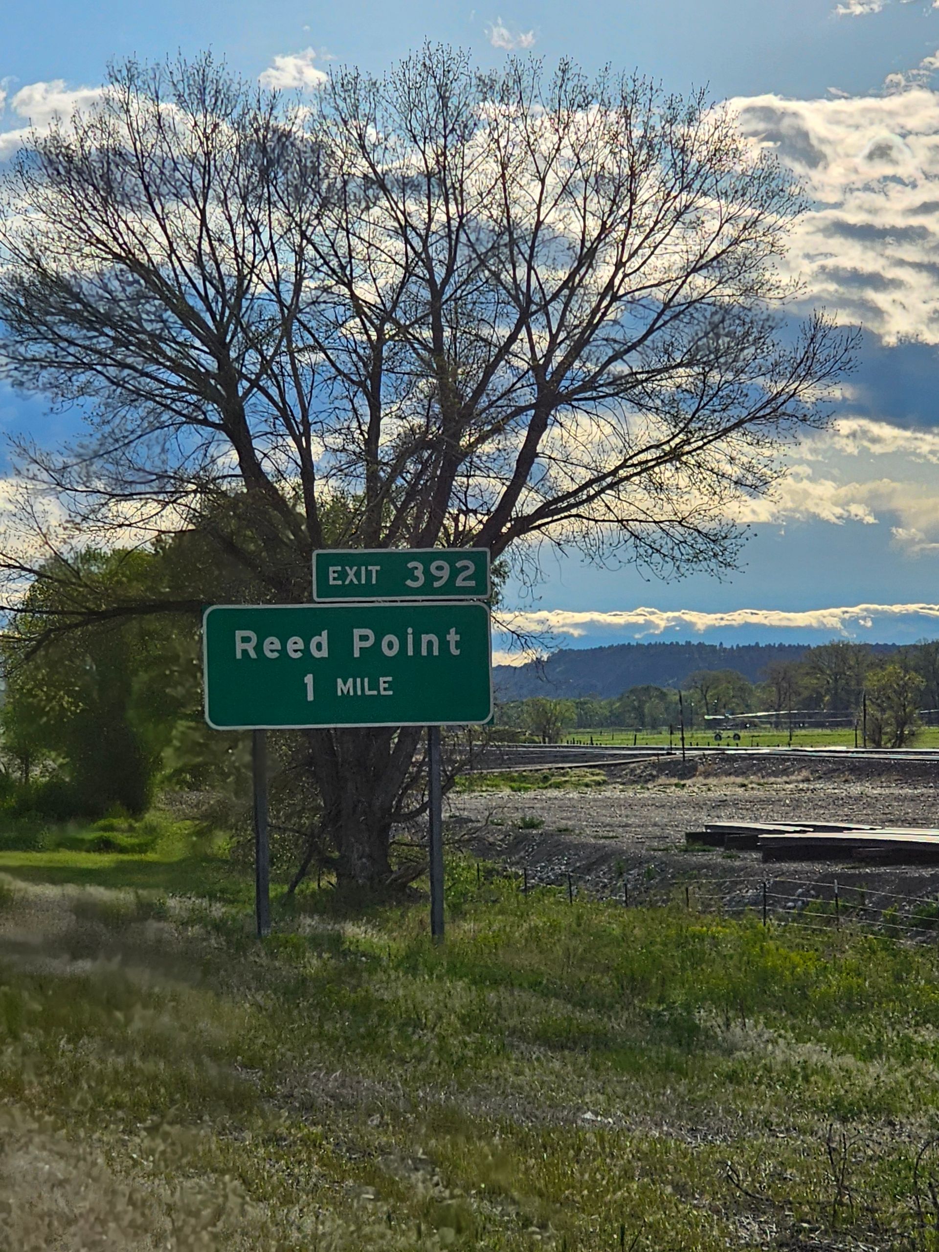 A green road sign that says reed point on it