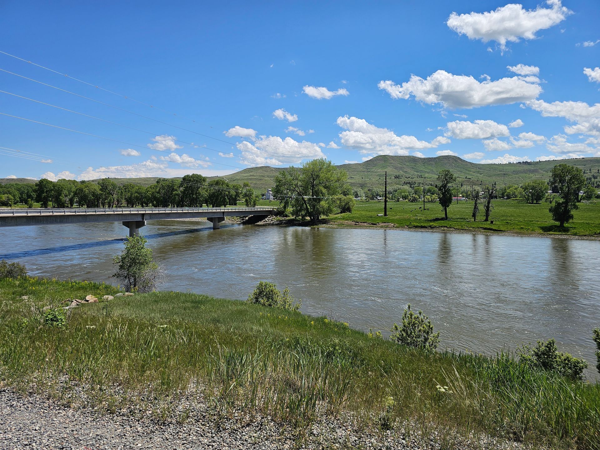 A bridge over a river with mountains in the background