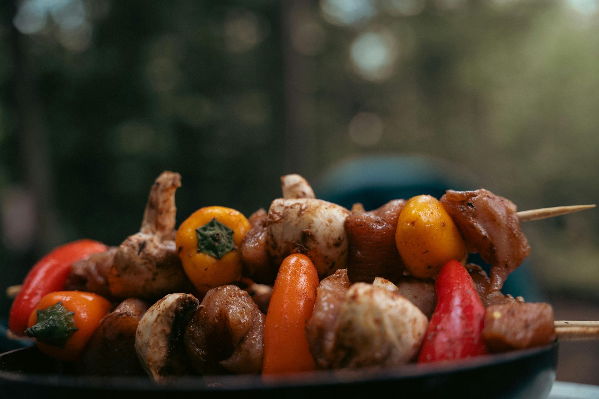 A plate of food with meat , carrots , rice and asparagus on a table.