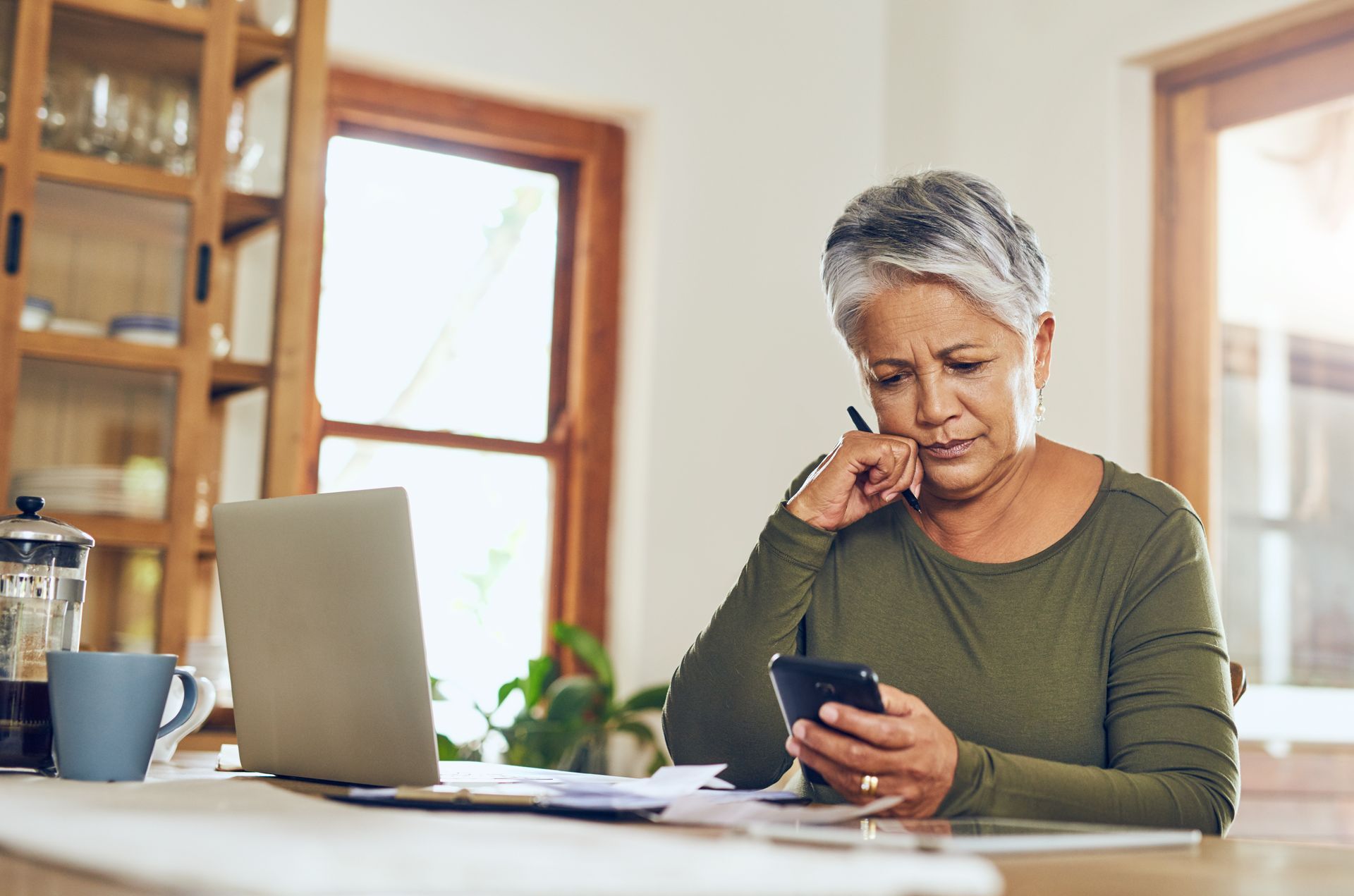 Senior woman, phone budget planning and health insurance checklist at home.