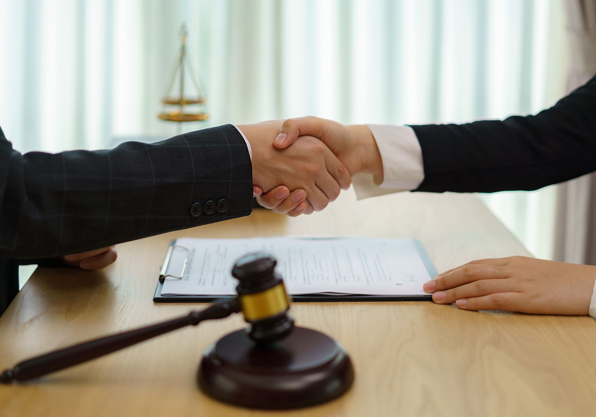 A handshake between a lawyer and a client, after a successful social security disability assistance.