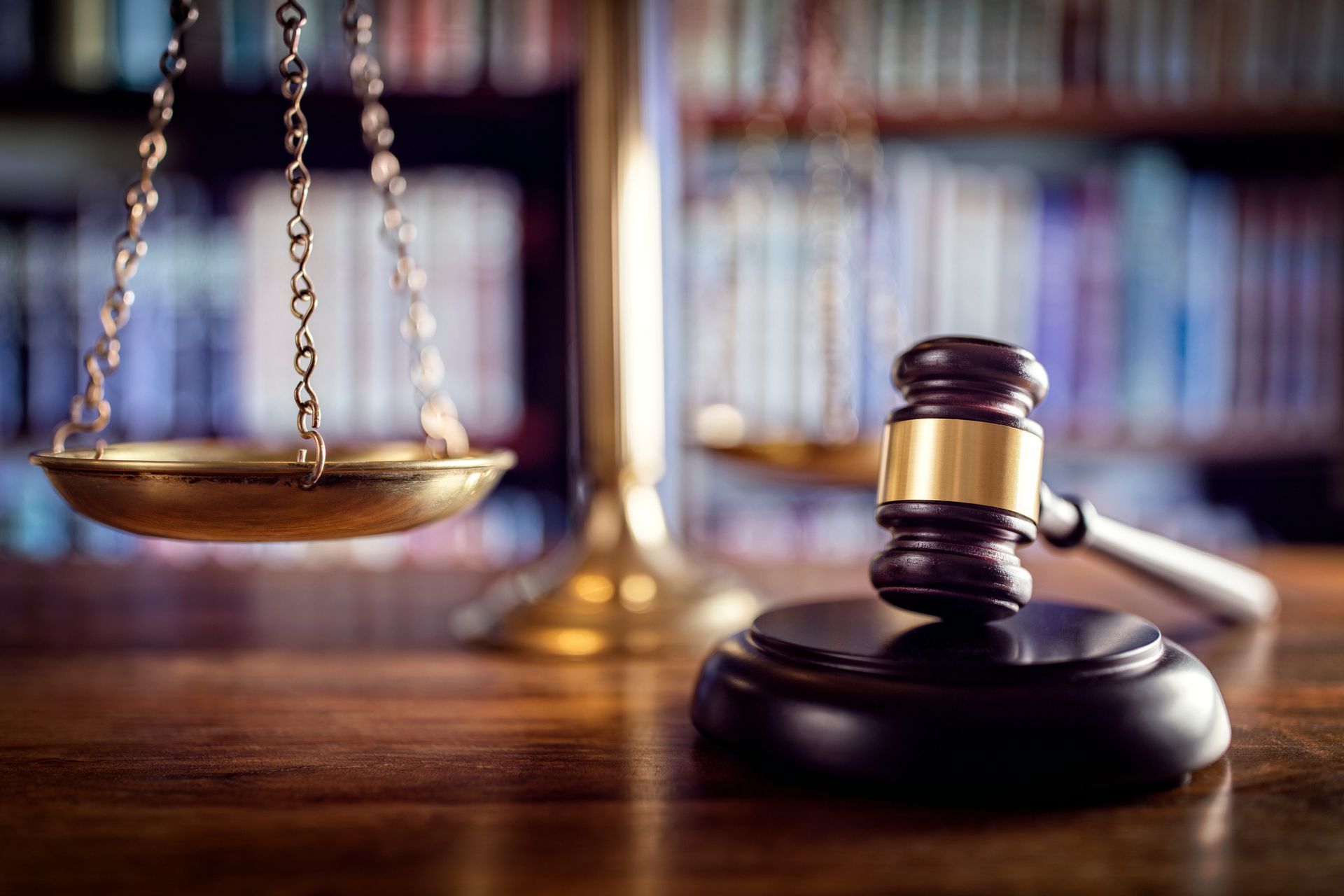 Scales of justice highlighting social security disability, with gavel and law books on desk.