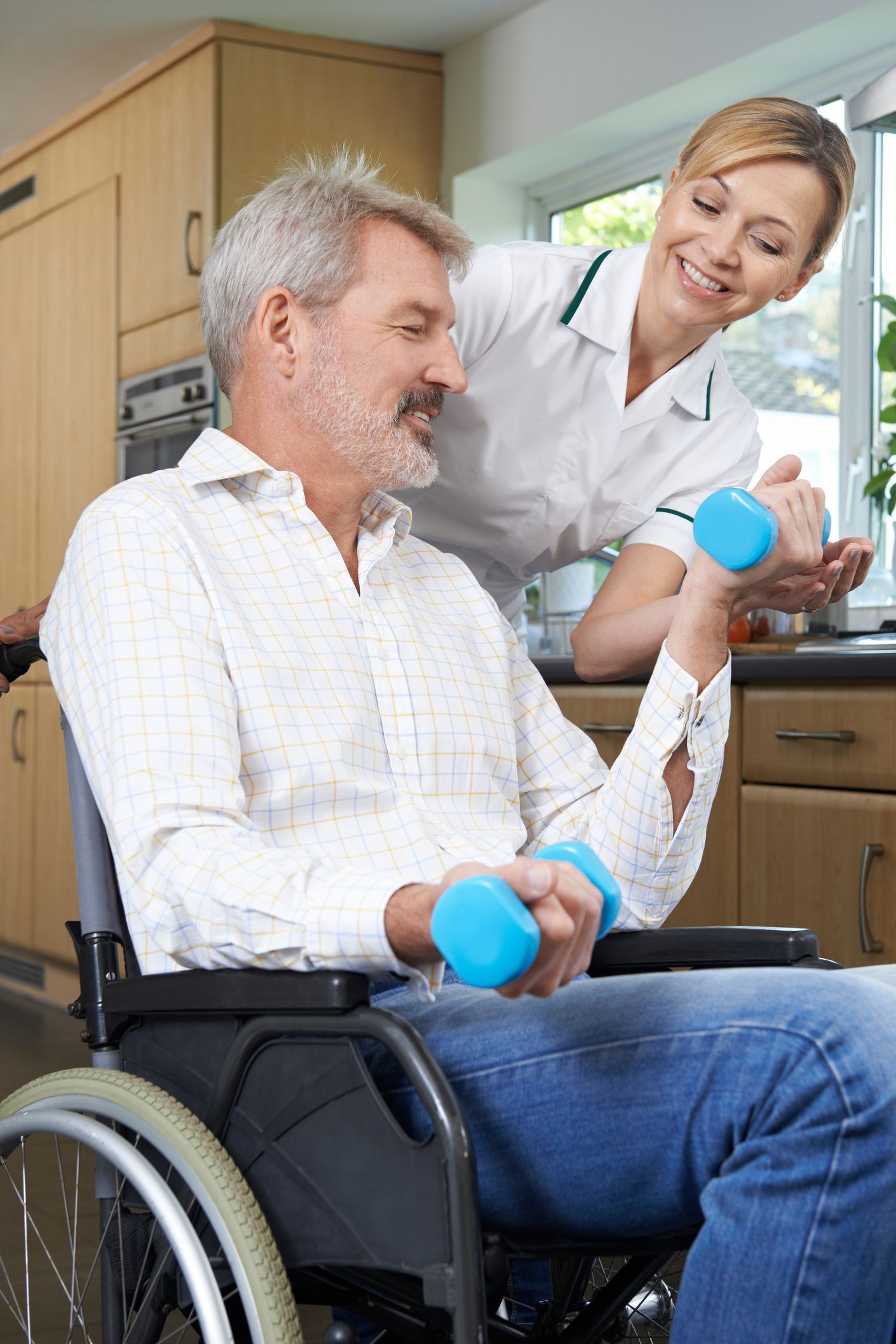 Physiotherapist helps man with using blue dumbbells, showcasing social security disability services.