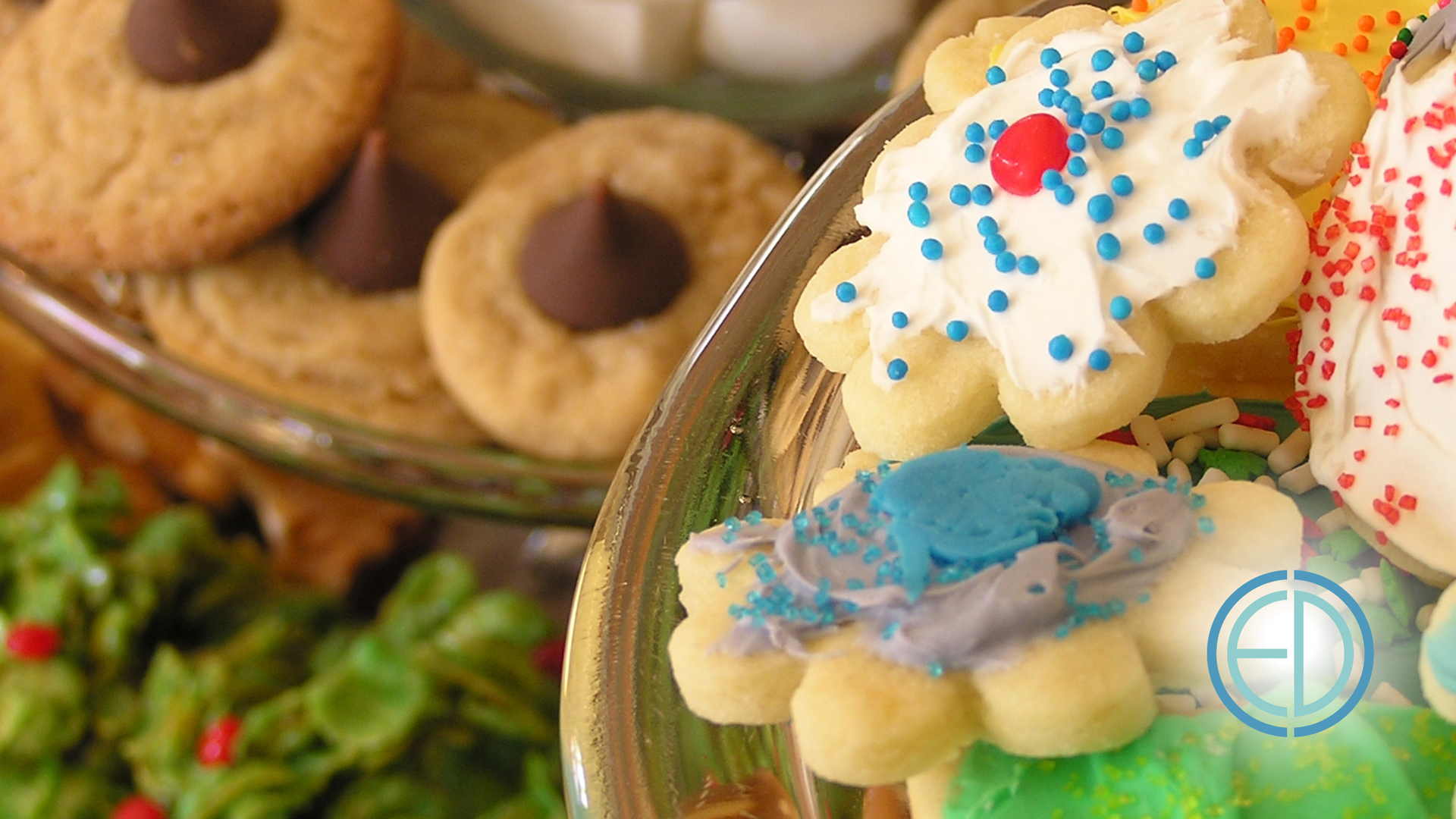 A glass bowl filled with a variety of christmas cookies