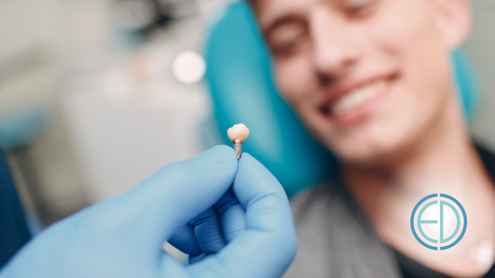 A dentist is holding a tooth in front of a patient in a dental chair.