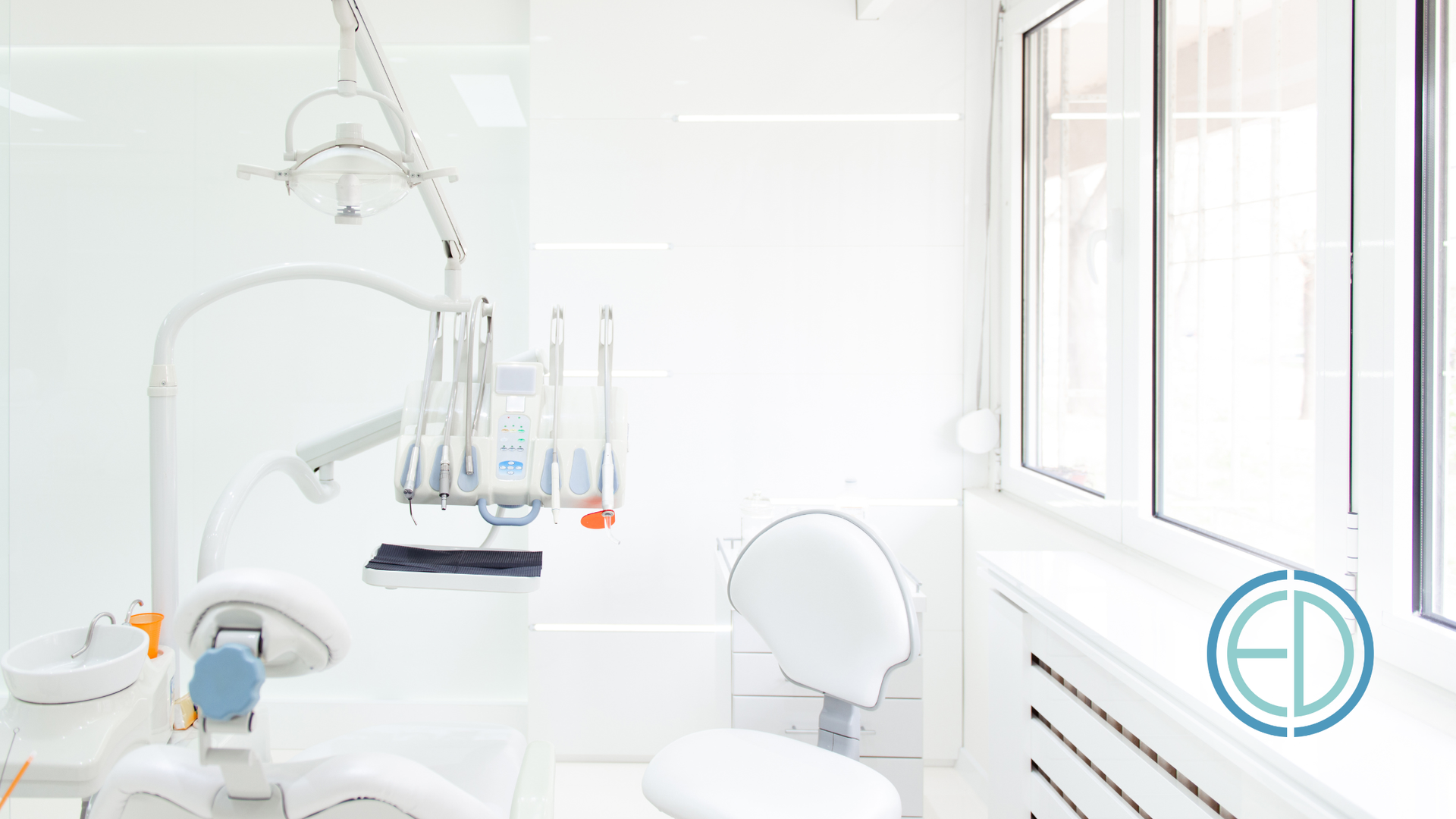 A bright, modern dental office with equipment, a chair, and a window.