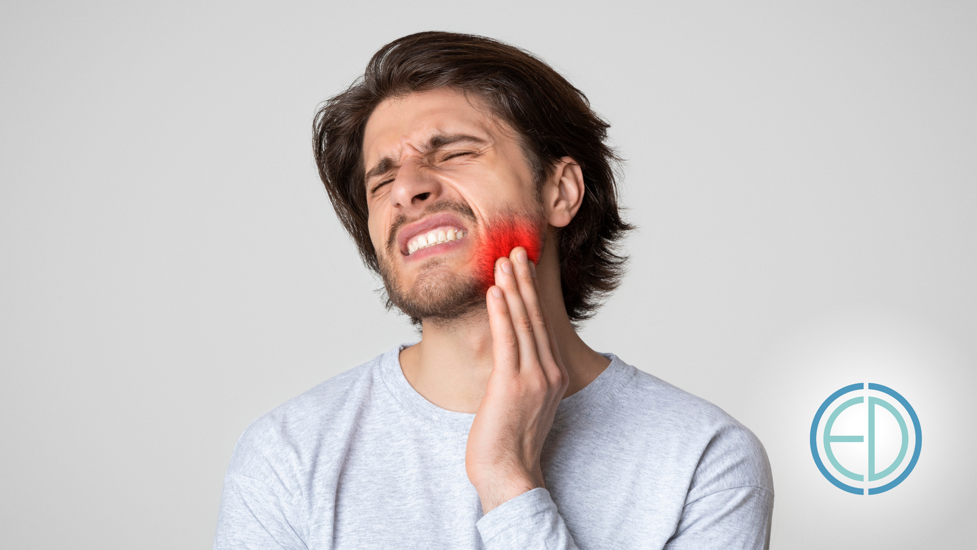 A man is holding his face in pain because of a toothache.