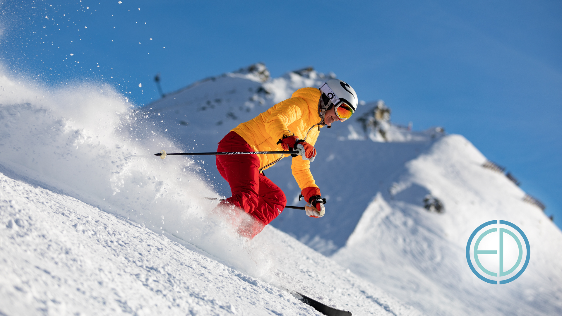 A person is skiing down a snow covered mountain.