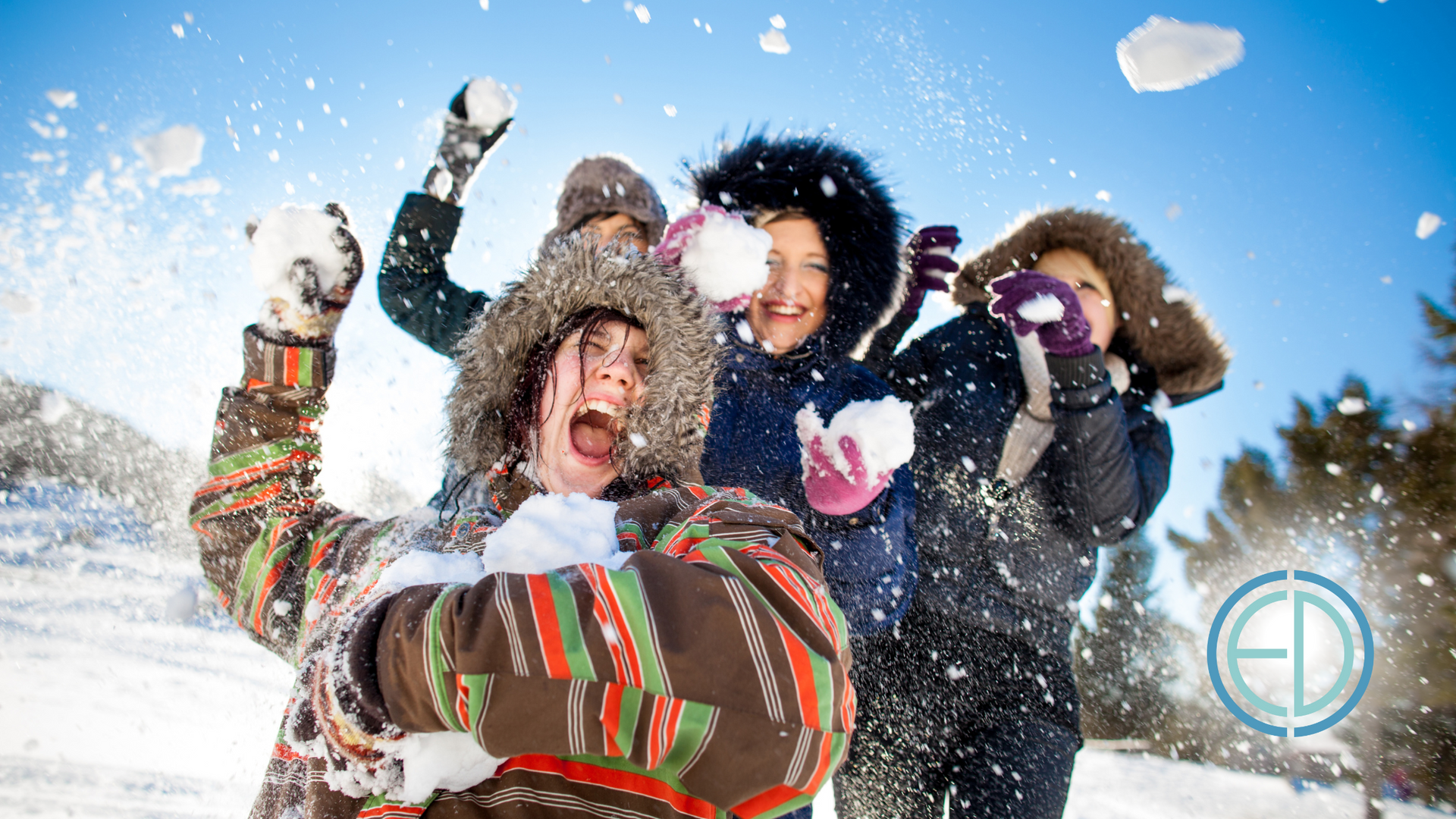 A group of people are playing in the snow.