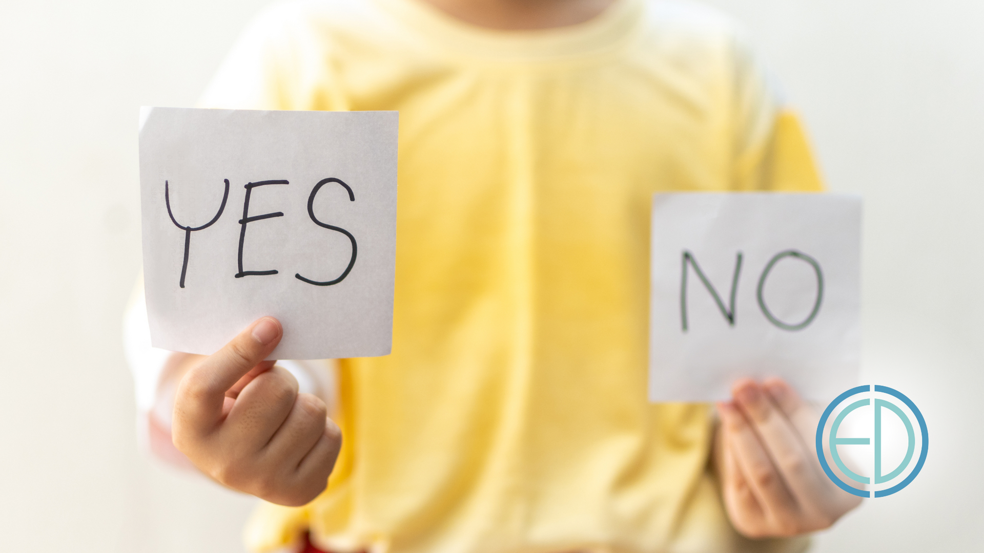 A person is holding a sign that says yes and another sign that says no