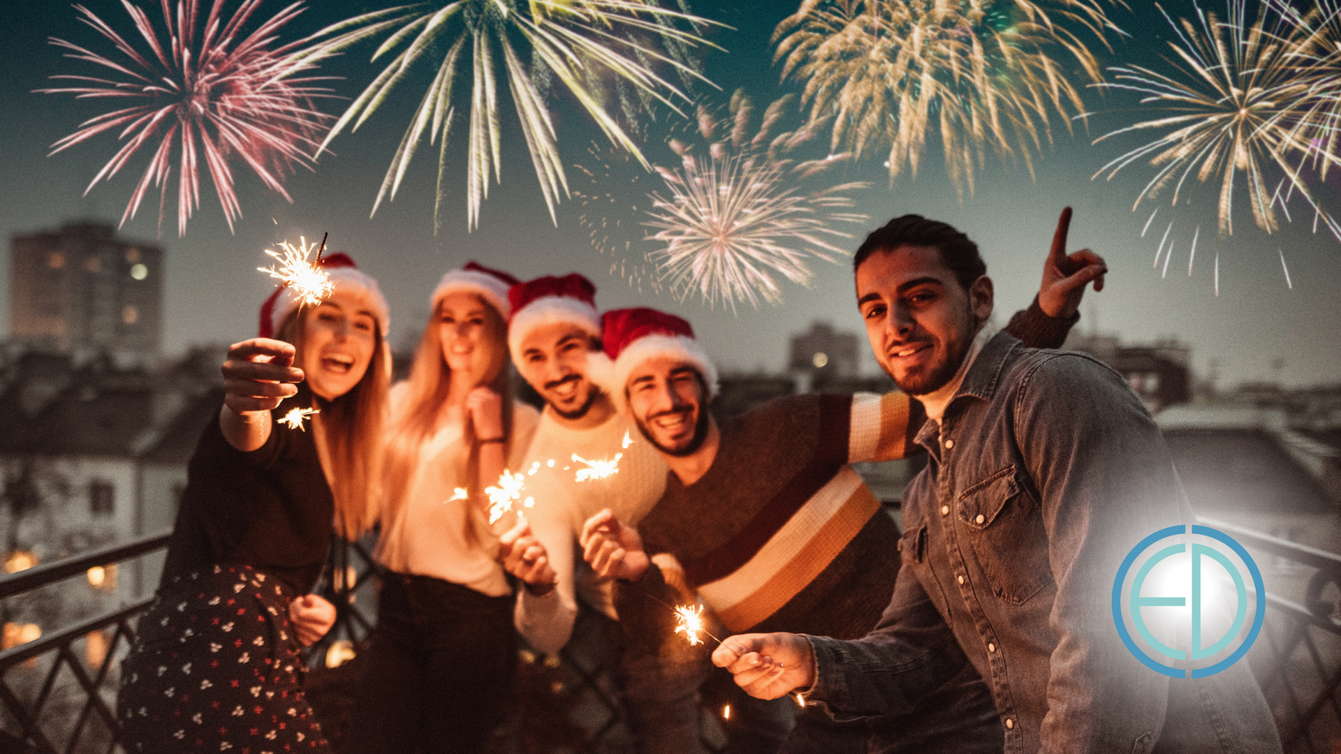 A group of people are holding sparklers in front of fireworks.