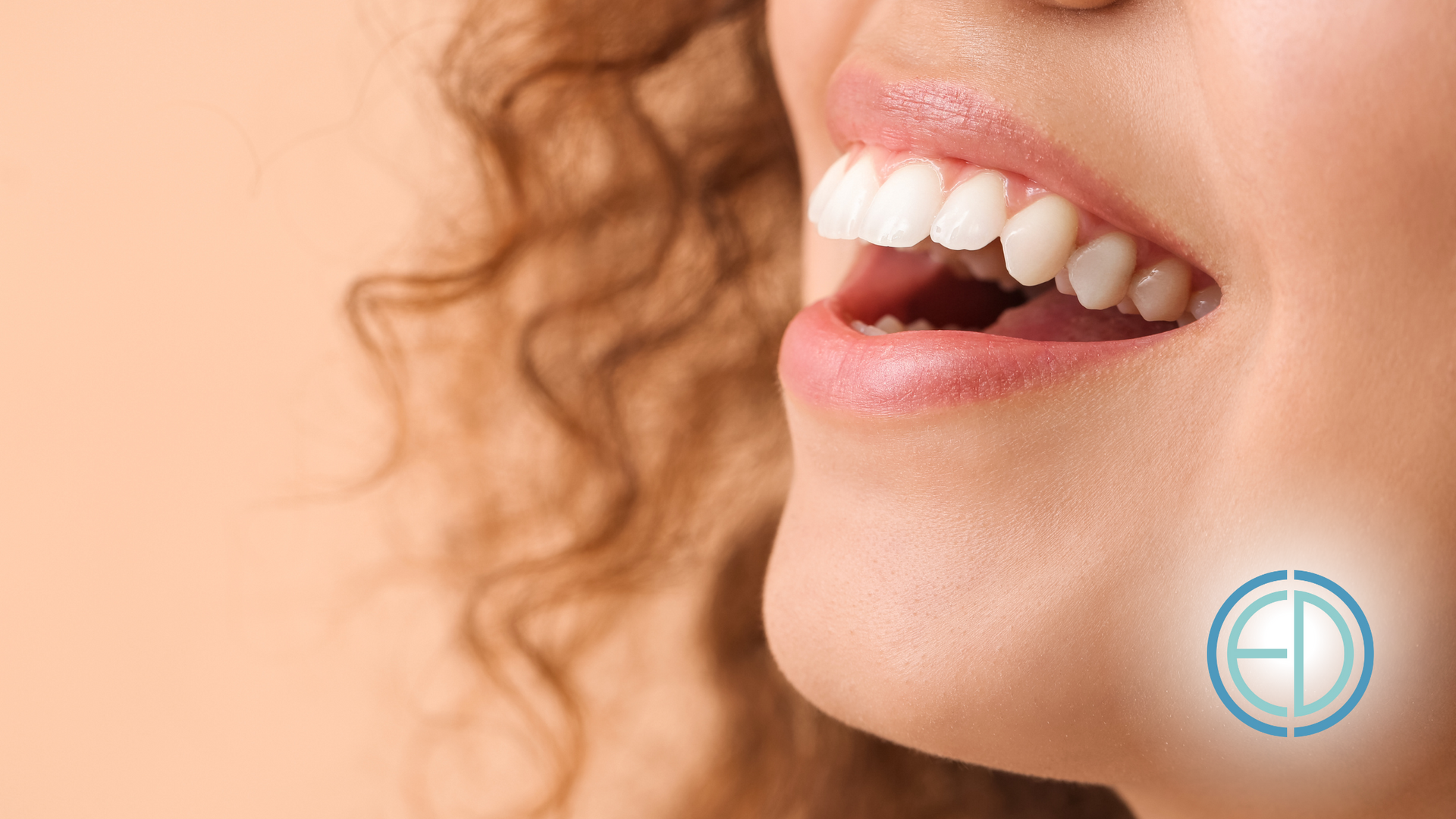 A close up of a woman 's mouth with white teeth.
