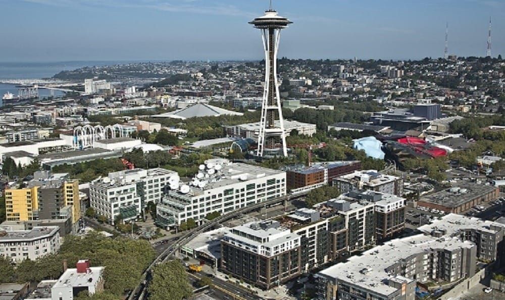 Aerial view of Seattle skyline with Space Needle and surrounding apartment buildings.