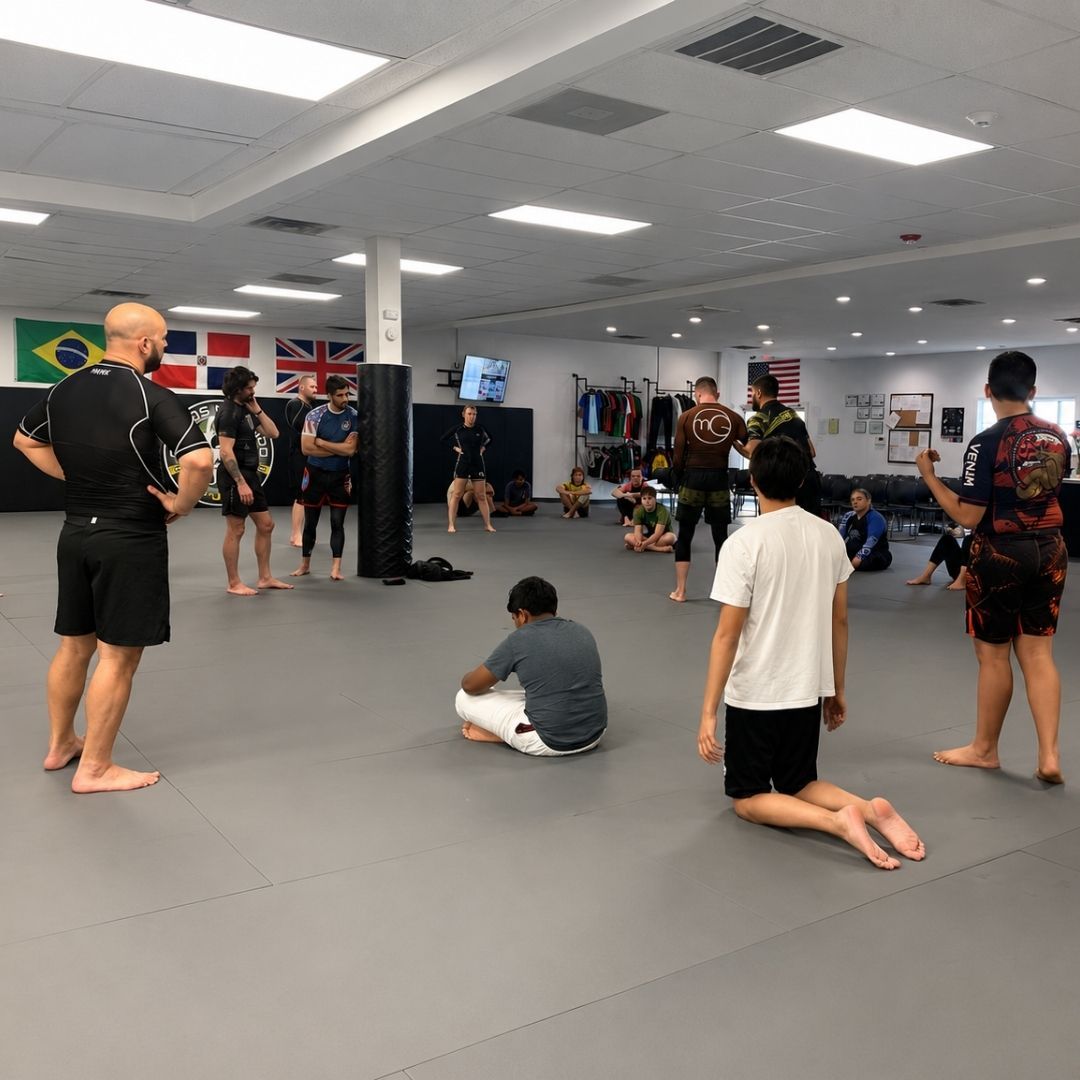 Group of children in martial arts attire posing, some with arms around each other, in a gym.