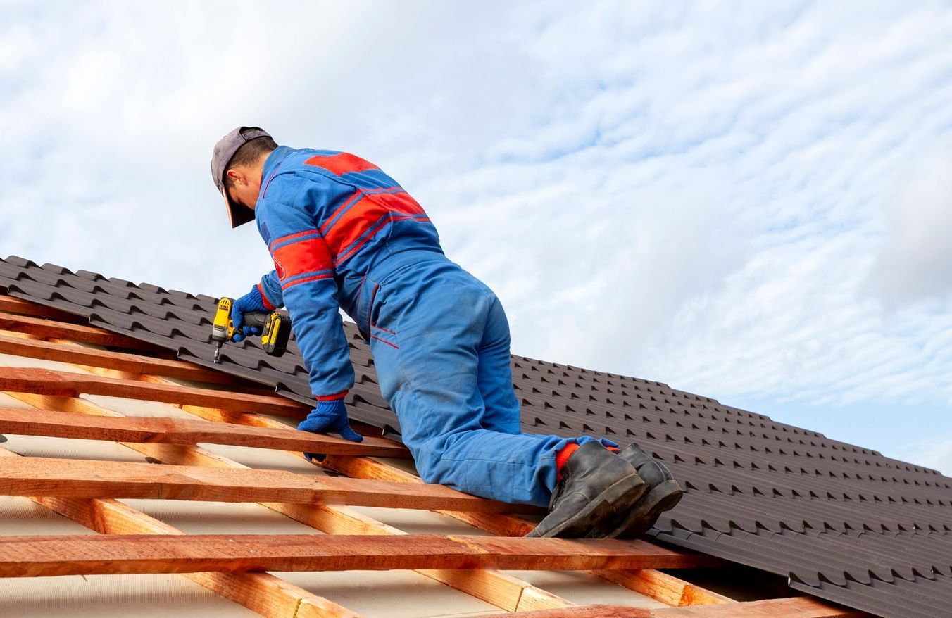 A man is working on the roof of a house. - Verona, VA - Quality Enterprises