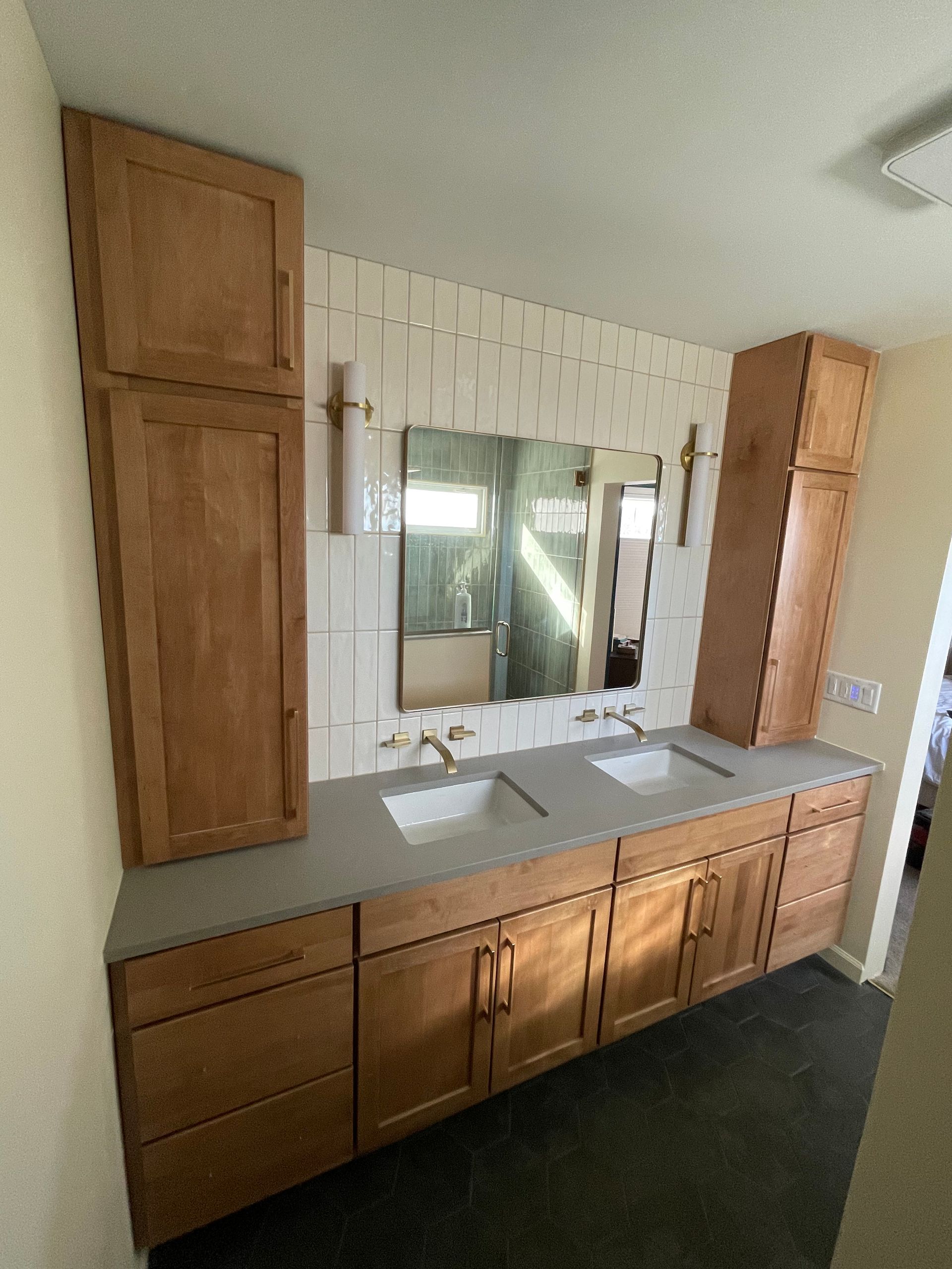 A bathroom with two sinks and a large mirror