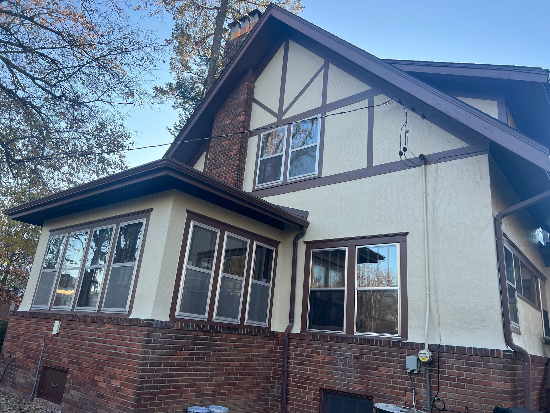 A large house with a lot of windows and a brick wall.