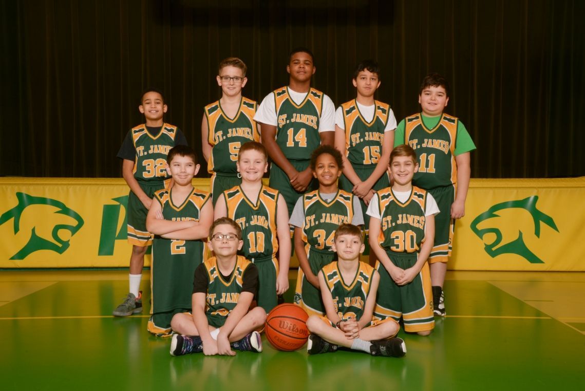 A basketball team posing for a picture with the number 14 on their jersey